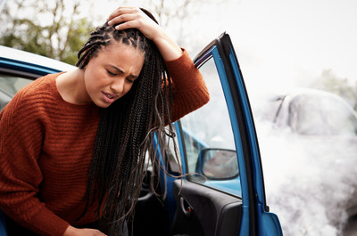 Lady with headache, holding head, concussion