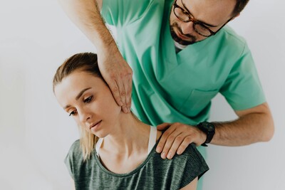 Physiotherapist working on a woman's neck