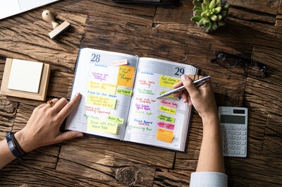 A woman planning her calendar for efficient daily planning.