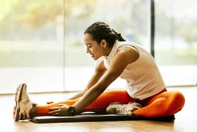 A woman with orange pants stretching